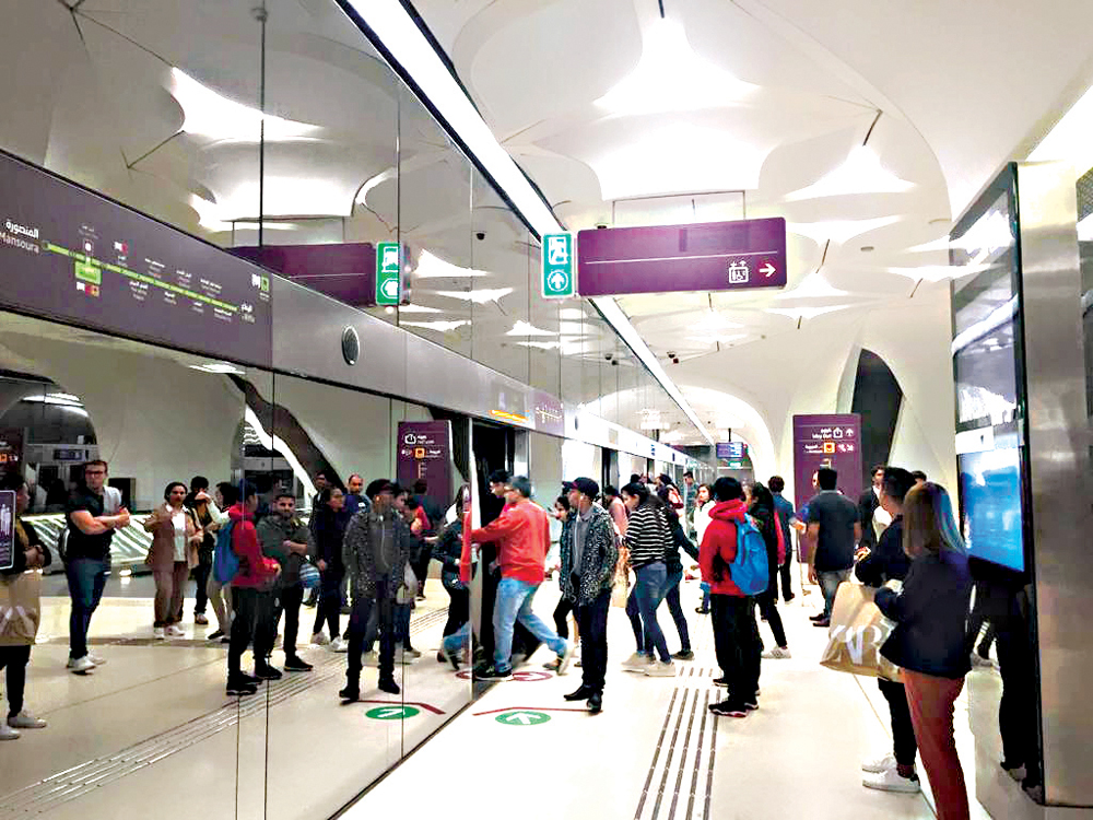 Doha metro passengers boarding a train at Msheireb metro station.