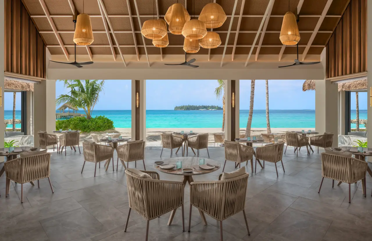 JW Marriott Kafu con cenas al aire libre, vistas marinas y escenario informal en el restaurante Vivo en Atul Eyland Resort, Maldivas.