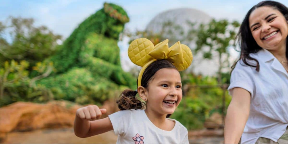 Niña y madre en el parque Epcot de Disney World con T-Fatty al fondo